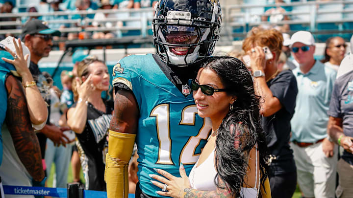 Jacksonville Jaguars player Travis Hunter (12) with his wife during pregame against the Houston Texans at EverBank Stadium.