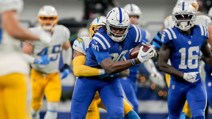Indianapolis Colts tight end Jelani Woods (80) is wrapped up by a Los Angeles Chargers defender as he secures a first down Monday, Dec. 26, 2022, during a game against the Los Angeles Chargers at Lucas Oil Stadium in Indianapolis.