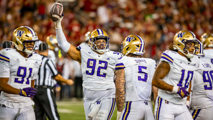 Bryce Butler holds up the Huskies' first fumble recovery of the season from the Apple Cup.