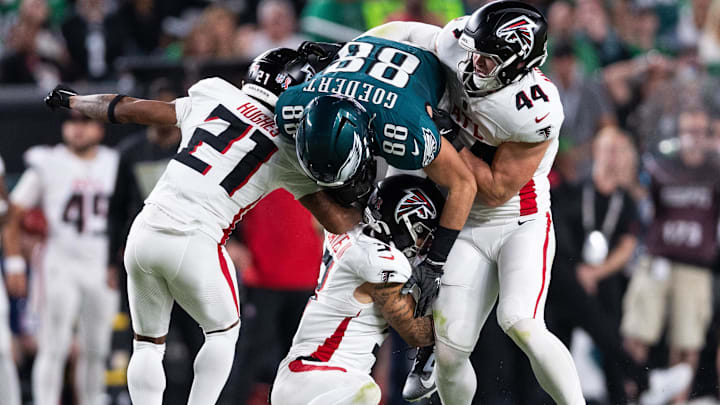 Sep 16, 2024; Philadelphia, Pennsylvania, USA; Philadelphia Eagles tight end Dallas Goedert (88) is tackled by Atlanta Falcons linebacker Troy Andersen (44) and cornerback Mike Hughes (21) after a catch during the second quarter at Lincoln Financial Field. Mandatory Credit: Bill Streicher-Imagn Images