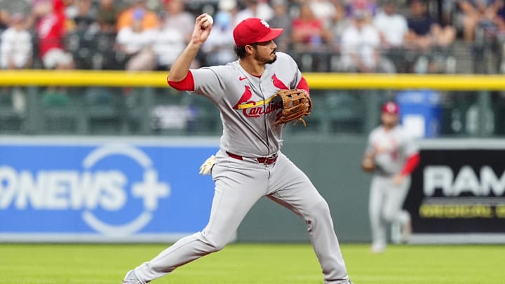 Jul 22, 2025; Denver, Colorado, USA; St. Louis Cardinals third baseman Nolan Arenado (28) fields the ball in the first inning against the Colorado Rockies at Coors Field. Mandatory Credit: Ron Chenoy-Imagn Images