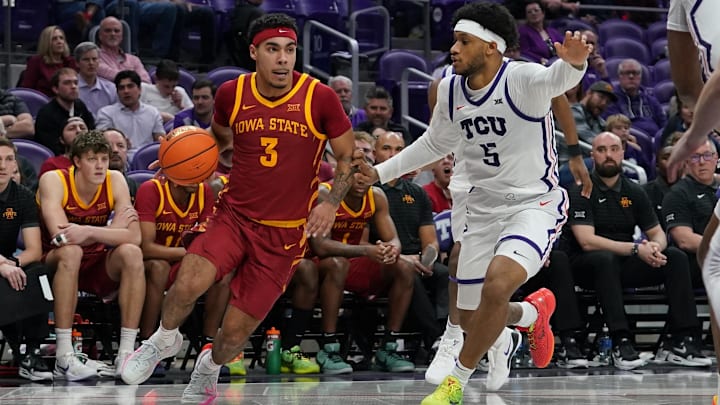 Feb 10, 2026; Fort Worth, Texas, USA;  Iowa State Cyclones guard Tamin Lipsey (3) dribbles as TCU Horned Frogs forward Micah Robinson (5) defends during the second half at Ed and Rae Schollmaier Arena.