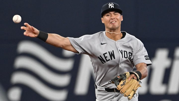 Jul 22, 2025; Toronto, Ontario, CAN;   New York Yankees shortstop Anthony Volpe (11) makes a throwing error against the Toronto Blue Jays in the sixth inning at Rogers Centre. Mandatory Credit: Dan Hamilton-Imagn Images