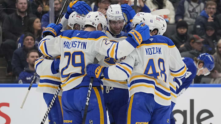 Jan 27, 2026; Toronto, Ontario, CAN; Buffalo Sabres forward Beck Malenstyn (29) and Buffalo Sabres forward Tyson Kozak (48) celebrate a goal by Buffalo Sabres defenseman Rasmus Dahlin (26) against the Toronto Maple Leafs during the second period at Scotiabank Arena. Mandatory Credit: John E. Sokolowski-Imagn Images