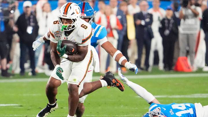 Miami (FL) Hurricanes running back CharMar Brown (6) runs past Mississippi Rebels safety Kapena Gushiken (14) in the first half during the Vrbo Fiesta Bowl and CFP semifinal game at State Farm Stadium on Jan. 8, 2026, in Glendale. Miami (FL) Hurricanes running back CharMar Brown (6) runs past Mississippi Rebels safety Kapena Gushiken (14) in the first half during the Vrbo Fiesta Bowl and CFP semifinal game at State Farm Stadium on Jan. 8, 2026, in Glendale.