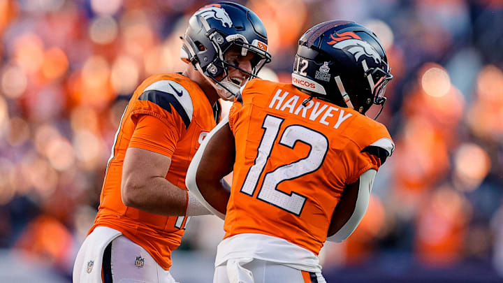 Oct 19, 2025; Denver, Colorado, USA; Denver Broncos quarterback Bo Nix (10) celebrates the touchdown of running back RJ Harvey (12) in the fourth quarter against the New York Giants at Empower Field at Mile High. 