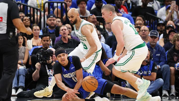 Apr 27, 2025; Orlando, Florida, USA; Orlando Magic guard Anthony Black (0) and Boston Celtics guard Payton Pritchard (11) scramble for a loose ball in the second quarter during game four of first round for the 2025 NBA Playoffs at Kia Center. Mandatory Credit: Nathan Ray Seebeck-Imagn Images