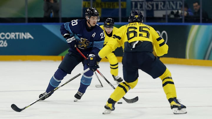 Feb 13, 2026; Milan, Italy; Sebastian Aho of Finland in action with Erik Karlsson of Sweden during a Group B men's ice hockey game during the Milano Cortina 2026 Olympic Winter Games at Milano Santagiulia Ice Hockey Arena. Mandatory Credit: Geoff Burke-Imagn Images