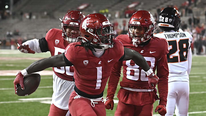 Pullman, Washington, USA; Washington State Cougars running back Angel Johnson (1) celebrates a a touchdown against the Oregon State Beavers in the second half at Gesa Field at Martin Stadium. Washington State Cougars won 32-8.