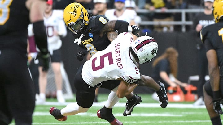Dec 2, 2023; Moscow, ID, USA; Southern Illinois Salukis wide receiver Izaiah Hartrup (5) is tackled by Idaho Vandals defensive back Ormanie Arnold (8) in the second half at Kibble Dome. Idaho won 20-17 in OT. Mandatory Credit: James Snook-USA TODAY Sports