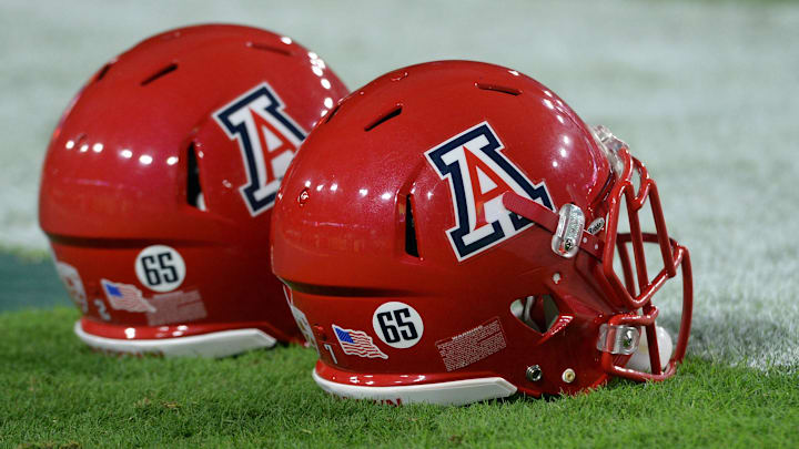 Sep 3, 2016; Glendale, AZ, USA; Stickers on the helmets of Arizona Wildcats platers depict depict the number 65 for deceased player Zach Hemmila (not pictured) prior to the game against the Brigham Young Cougars at University of Phoenix Stadium. Mandatory Credit: Joe Camporeale-Imagn Images