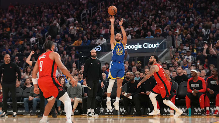 Golden State Warriors guard Stephen Curry shoots over Houston Rockets guard Fred VanVleet.