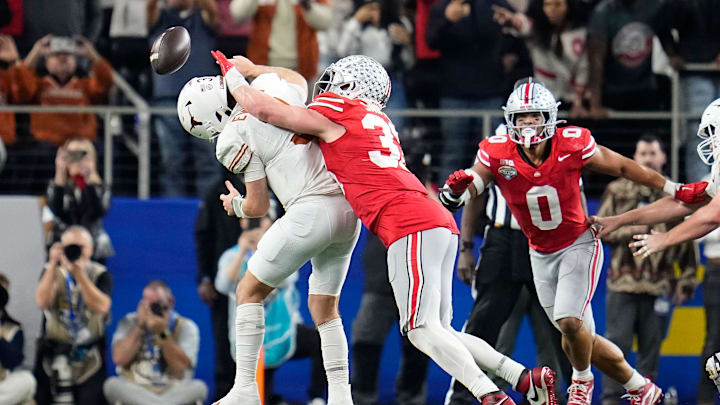 Ohio State Buckeyes defensive end Jack Sawyer (33) sacks Texas Longhorns quarterback Quinn Ewers (3) forcing a fumble during the second half of the Cotton Bowl Classic College Football Playoff semifinal game at AT&T Stadium in Arlington, Texas on Jan. 10, 2025. Sawyer returned the fumble for a touchdown, and Ohio State won 28-14.