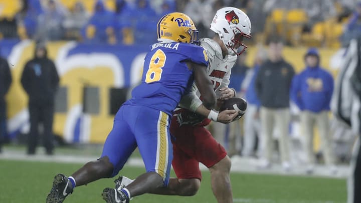 Oct 14, 2023; Pittsburgh, Pennsylvania, USA; Pittsburgh Panthers defensive lineman Samuel Okunlola (8) sacks Louisville Cardinals quarterback Jack Plummer (13) causing Plummer to fumble during the second quarter at Acrisure Stadium. Mandatory Credit: Charles LeClaire-Imagn Images
