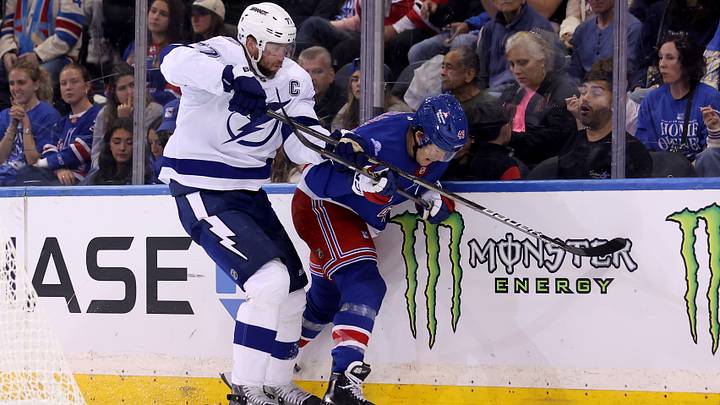 Oct 1, 2026; New York, New York, USA; Tampa Bay Lightning defenseman Victor Hedman (77) and New York Rangers right wing Jaroslav Chmelar (49) fight for the puck during the third period at Madison Square Garden. Mandatory Credit: Brad Penner-Imagn Images