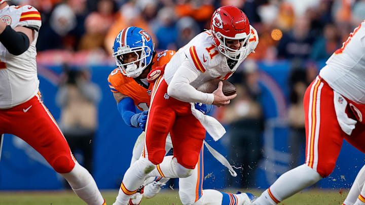 Jan 5, 2025; Denver, Colorado, USA; Kansas City Chiefs quarterback Carson Wentz (11) is sacked by Denver Broncos linebacker Nik Bonitto (15) in the third quarter at Empower Field at Mile High. Mandatory Credit: Isaiah J. Downing-Imagn Images