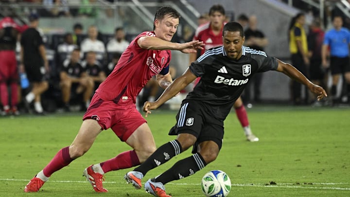 Jul 30, 2025; St. Louis, Missouri, USA; St. Louis City midfielder Chris Durkin (8) battles Aston Villa midfielder Youri Tielemans (8) for the ball in the second half at Energizer Park. Mandatory Credit: Joe Puetz-Imagn Images