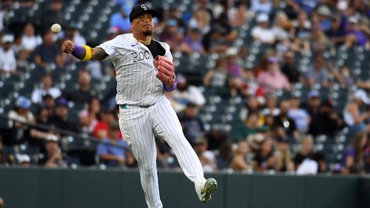 Sep 7, 2025; Denver, Colorado, USA; Colorado Rockies third baseman Orlando Arcia (11) throws to first for an out during the seventh inning against the San Diego Padres at Coors Field.