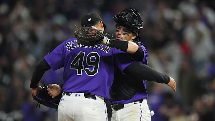 Apr 7, 2026; Denver, Colorado, USA; Colorado Rockies relief pitcher Antonio Senzatela (49) and catcher Brett Sullivan (26) celebrate defeating the Houston Astros in the inning at Coors Field. Mandatory Credit: Ron Chenoy-Imagn Images