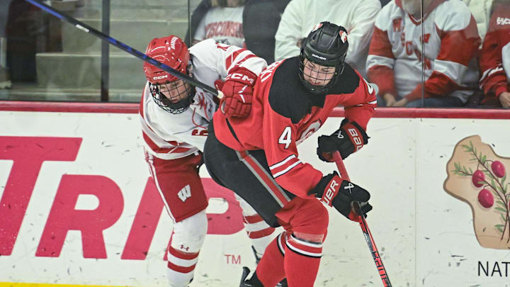 Wisconsin right wing Lacey Eden (6) and Ohio State defender Sara Swinderski (4) collide at the puck in a game Sunday, February 8, 2026, at LaBahn Arena in Madison, Wisconsin.