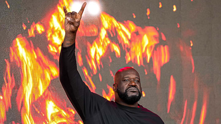 Shaquille O'Neal holds up the sign of the horns during a DJ performance ahead of the College Football Playoff semifinal game between the Texas Longhorns and Ohio State in the Cotton Bowl at AT&T Stadium on Friday, Jan. 10, 2024 in Arlington, Texas.