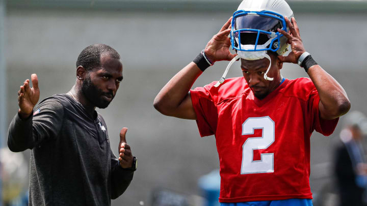 Detroit Lions assistant quarterbacks coach J.T. Barrett talks to quarterback Hendon Hooker