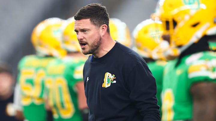 Jan 1, 2024; Glendale, AZ, USA; Oregon Ducks head coach Dan Lanning watches from the sidelines during warm ups before the 2024 Fiesta Bowl against the Liberty Flames at State Farm Stadium. Mandatory Credit: Mark J. Rebilas-USA TODAY Sports