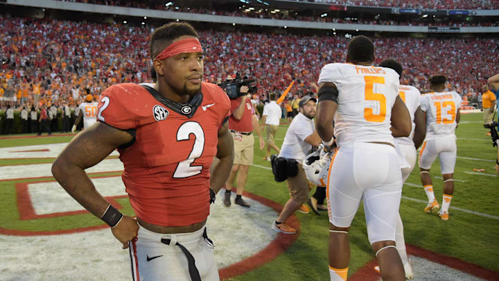 Oct 1, 2016; Athens, GA, USA; Georgia Bulldogs defensive back Maurice Smith (2) reacts in front of celebrating Tennessee Volunteers players after a game winning touchdown pass on the last play on the game during the fourth quarter at Sanford Stadium. Tennessee defeated Georgia 34-31. Mandatory Credit: Dale Zanine-Imagn Images