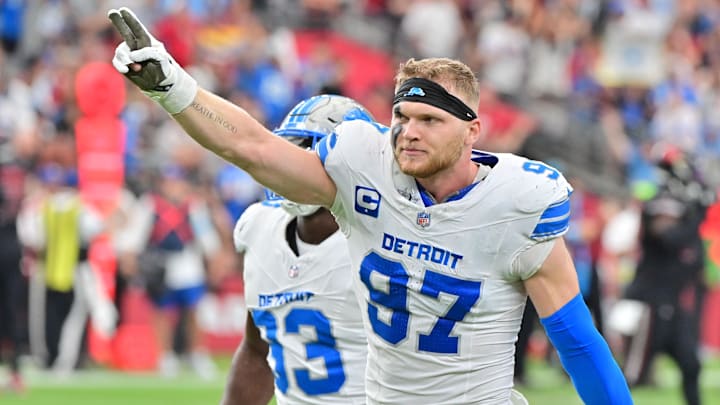 Sep 22, 2024; Glendale, Arizona, USA;  Detroit Lions defensive end Aidan Hutchinson (97) and defensive end Josh Paschal (93) celebrate after stopping the Arizona Cardinals on 4th and 1 in the second half at State Farm Stadium.