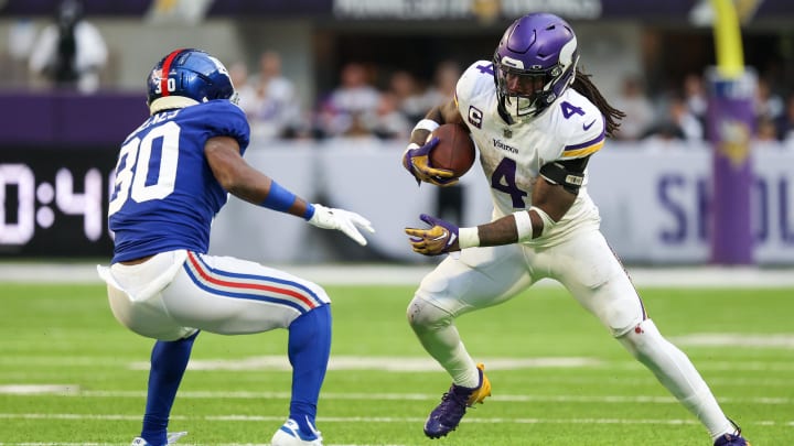 Dec 24, 2022; Minneapolis, Minnesota, USA; Minnesota Vikings running back Dalvin Cook (4) runs after a catch while New York Giants cornerback Darnay Holmes (30) defends during the third quarter at U.S. Bank Stadium. Mandatory Credit: Matt Krohn-USA TODAY Sports