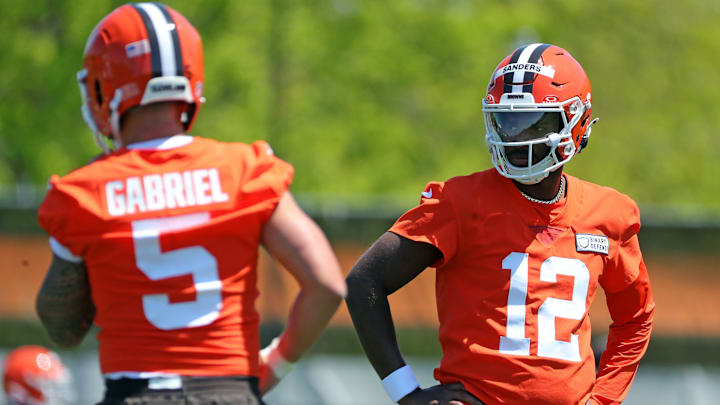 Cleveland Browns quarterback Shedeur Sanders (12) watches quarterback Dillon Gabriel (5) during day two of NFL rookie minicamp at the Cleveland Browns training facility on Saturday, May 10, 2025, in Berea, Ohio.