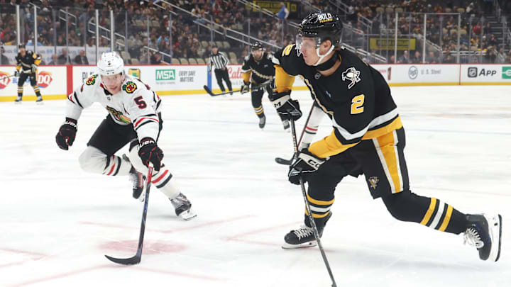 Apr 8, 2025; Pittsburgh, Pennsylvania, USA;  Pittsburgh Penguins right wing Rutger McGroarty (2) shoots the puck as Chicago Blackhawks defenseman Connor Murphy (5) defends during the first period at PPG Paints Arena. Mandatory Credit: Charles LeClaire-Imagn Images