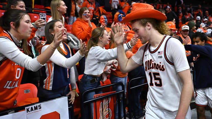 Nov 11, 2025; Champaign, Illinois, USA; Illinois Fighting Illini forward Jake Davis (15) greet fans in the student section after the game against the Texas Tech Red Raiders at State Farm Center. Mandatory Credit: Ron Johnson-Imagn Images