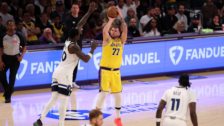 Apr 22, 2025; Los Angeles, California, USA; Los Angeles Lakers guard Luka Doncic (77) shoots the ball over Minnesota Timberwolves forward Julius Randle (30) during the third quarter of game two of first round for the 2024 NBA Playoffs at Crypto.com Arena. Mandatory Credit: Kiyoshi Mio-Imagn Images