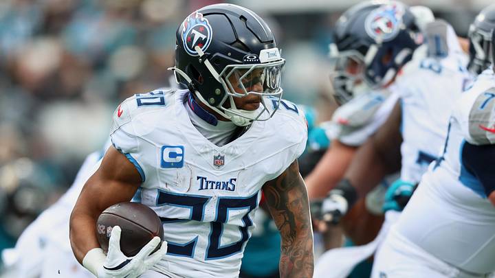 Jan 4, 2026; Jacksonville, Florida, USA; Tennessee Titans running back Tony Pollard (20) runs the ball against the Jacksonville Jaguars during the first quarter at EverBank Stadium. Mandatory Credit: Morgan Tencza-Imagn Images