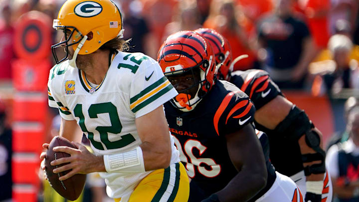 Green Bay Packers quarterback Aaron Rodgers (12) scrambles out of the pocket as Cincinnati Bengals defensive end Cameron Sample (96) gives chase in the first quarter of a Week 5 NFL football game, Sunday, Oct. 10, 2021, at Paul Brown Stadium in Cincinnati.

Green Bay Packers At Cincinnati Bengals Oct 10