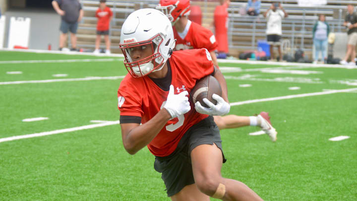 Lee Evans IV runs with the ball during a Wisconsin Badgers football camp at Camp Randall Stadium on June 8, 2025.