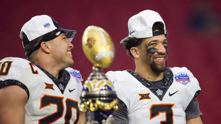 Jan 1, 2022; Glendale, Arizona, USA; Oklahoma State Cowboys linebacker Malcolm Rodriguez (20) and quarterback Spencer Sanders (3) celebrate after defeating the Notre Dame Fighting Irish during the 2022 Fiesta Bowl at State Farm Stadium. Mandatory Credit: Mark J. Rebilas-USA TODAY Sports Jan 1, 2022; Glendale, Arizona, USA; Oklahoma State Cowboys linebacker Malcolm Rodriguez (20) and quarterback Spencer Sanders (3) celebrate after defeating the Notre Dame Fighting Irish during the 2022 Fiesta Bowl at State Farm Stadium. Mandatory Credit: Mark J. Rebilas-USA TODAY Sports
