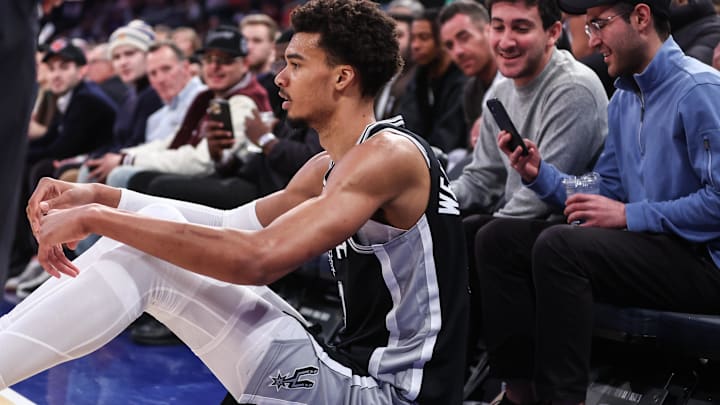 San Antonio Spurs center Victor Wembanyama sits on the floor after getting fouled in the third quarter against the New York Knicks.