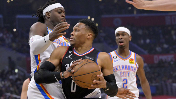 Mar 23, 2023; Los Angeles, California, USA; Oklahoma City Thunder guard Luguentz Dort (5) moves in against Los Angeles Clippers guard Russell Westbrook (0) in the first half at Crypto.com Arena. Mandatory Credit: Jayne Kamin-Oncea-USA TODAY Sports