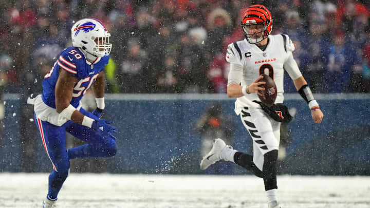 Cincinnati Bengals quarterback Joe Burrow (9) carries the ball as Buffalo Bills defensive end Greg Rousseau (50) defends in the second quarter during an NFL divisional playoff football game between the Cincinnati Bengals and the Buffalo Bills, Sunday, Jan. 22, 2023, at Highmark Stadium in Orchard Park, N.Y.

Cincinnati Bengals At Buffalo Bills Afc Divisional Jan 22 1207
