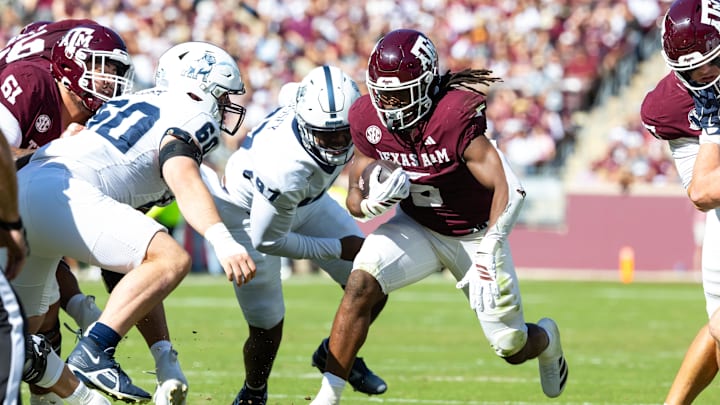 Nov 22, 2025; College Station, Texas, USA; Texas A&M Aggies running back Amari Daniels (5) runs with the ball in the first half of a game against the Samford Bulldogs at Kyle Field. Mandatory Credit: Joseph Buvid-Imagn Images