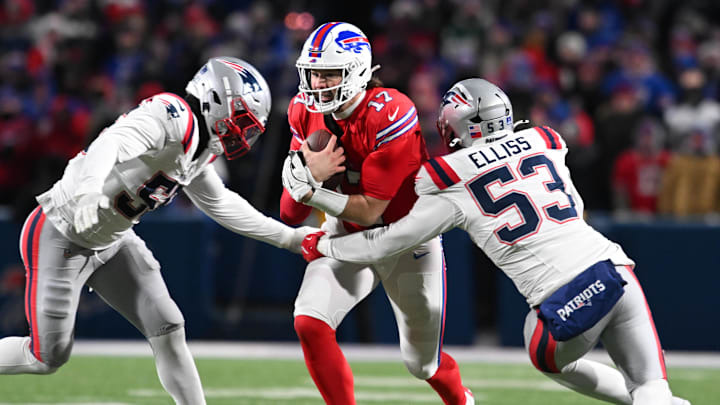 Dec 22, 2024; Orchard Park, New York, USA; Buffalo Bills quarterback Josh Allen (17) is tackled by New England Patriots linebacker Yannick Ngakoue (55) and linebacker Christian Elliss (53) in the fourth quarter at Highmark Stadium.