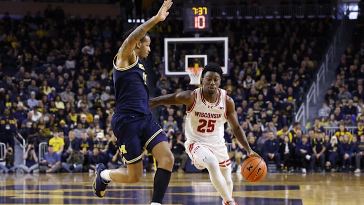 Jan 10, 2026; Ann Arbor, Michigan, USA;  Wisconsin Badgers guard John Blackwell (25) dribbles defended by Michigan Wolverines guard Roddy Gayle Jr. (11) in the second half at Crisler Center. Mandatory Credit: Rick Osentoski-Imagn Images