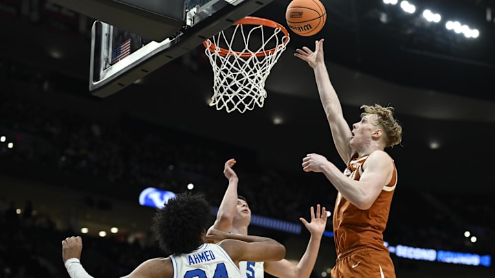 Mar 19, 2026; Portland, OR, USA; Texas Longhorns center Matas Vokietaitis (8) shoots against BYU Cougars center Abdullah Ahmed (34) and forward Mihailo Boskovic (5) during a first-round game of the NCAA Tournament.