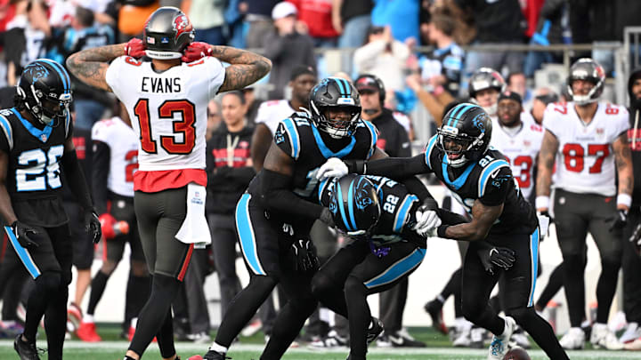 Dec 21, 2025; Charlotte, North Carolina, USA; Carolina Panthers safety Lathan Ransom (22) celebrates with linebacker Nic Scourton (11) and safety Nick Scott (21) after intercepting the ball to seal the victory in the fourth quarter as Tampa Bay Buccaneers wide receiver Mike Evans (13) reacts at Bank of America Stadium. Mandatory Credit: Bob Donnan-Imagn Images Dec 21, 2025; Charlotte, North Carolina, USA; Carolina Panthers safety Lathan Ransom (22) celebrates with linebacker Nic Scourton (11) and safety Nick Scott (21) after intercepting the ball to seal the victory in the fourth quarter as Tampa Bay Buccaneers wide receiver Mike Evans (13) reacts at Bank of America Stadium. Mandatory Credit: Bob Donnan-Imagn Images