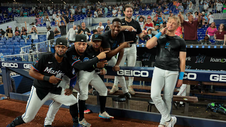 Jul 18, 2025; Miami, Florida, USA; Miami Marlins left fielder Kyle Stowers (right) celebrates with teammates after hitting a two-run walk-off home run against the Kansas City Royals during the tenth inning at loanDepot Park. Mandatory Credit: Sam Navarro-Imagn Images