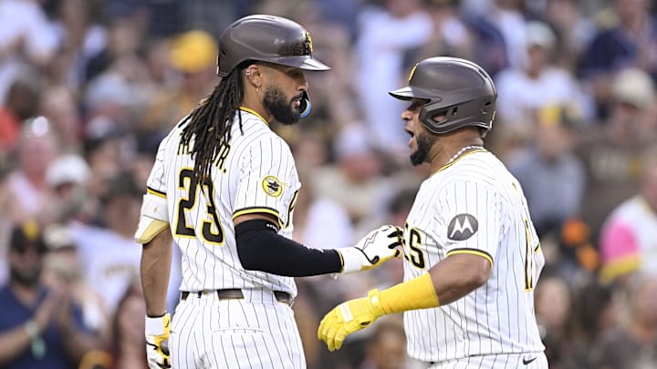 Sep 27, 2025; San Diego, California, USA; San Diego Padres catcher Elias Diaz (17) is congratulated by Fernando Tatis Jr. (23) after hitting a solo home run during the second inning against the Arizona Diamondbacks at Petco Park. Mandatory Credit: Denis Poroy-Imagn Images