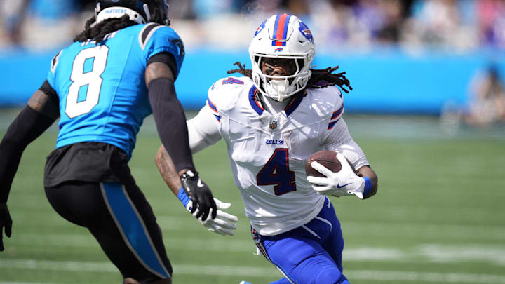 Oct 26, 2025; Charlotte, North Carolina, USA; Buffalo Bills running back James Cook III (4) runs against Carolina Panthers cornerback Jaycee Horn (8) during the first half at Bank of America Stadium.