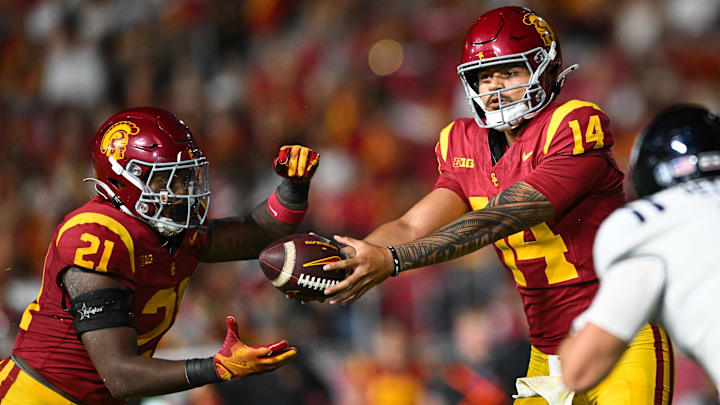 Sep 7, 2024; Los Angeles, California, USA; USC Trojans quarterback Jayden Maiava (14) hands off the ball to USC Trojans running back Bryan Jackson (21) against the Utah State Aggies during the third quarter at United Airlines Field at Los Angeles Memorial Coliseum. Mandatory Credit: Jonathan Hui-Imagn Images Sep 7, 2024; Los Angeles, California, USA; USC Trojans quarterback Jayden Maiava (14) hands off the ball to USC Trojans running back Bryan Jackson (21) against the Utah State Aggies during the third quarter at United Airlines Field at Los Angeles Memorial Coliseum. Mandatory Credit: Jonathan Hui-Imagn Images